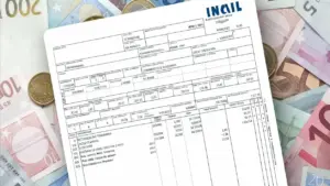 Busta paga italiana appoggiata su banconote e monete in euro