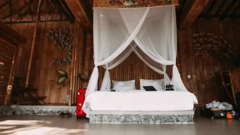 Letto con zanzariera in una camera da letto in legno dal design tropicale