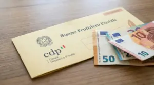 Buono fruttifero postale e banconote in euro su un tavolo