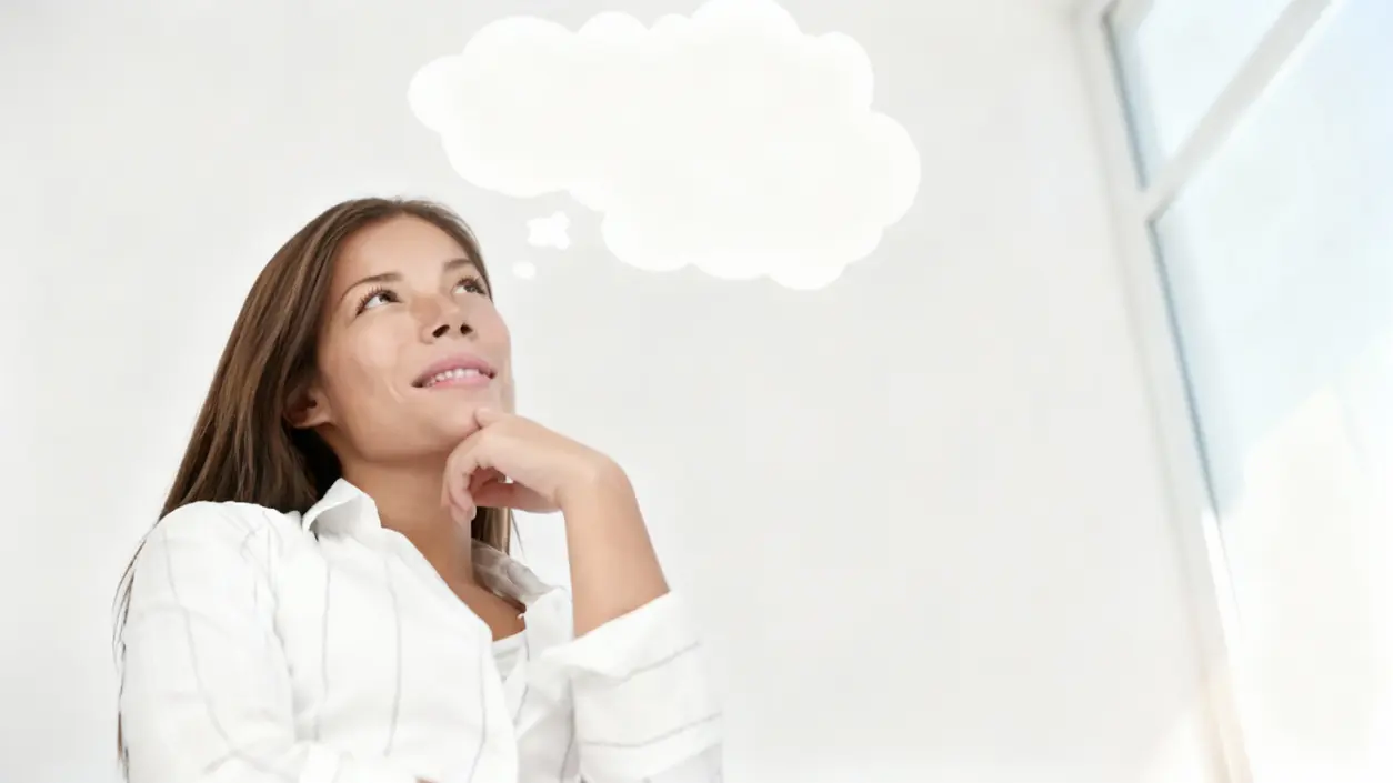 Persona pensierosa con uno sfondo chiaro e una nuvoletta sopra la testa